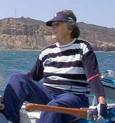 Captain Muriel at the tiller
